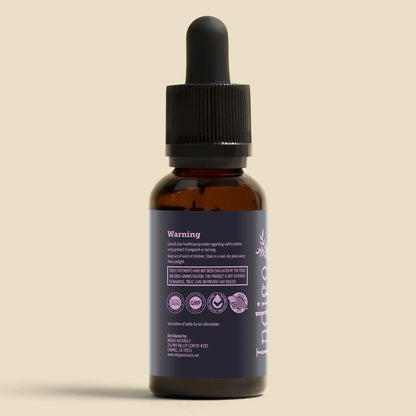 Pure CBD isolate oil 6000mg bottle with dropper and warning label by Indigo Naturals.